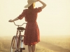 Woman in hat with a bike