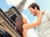Couple embracing in front of Eiffel Tower