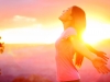 Happy woman enjoying sunset