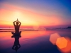 Silhouette of woman sitting on sea coast