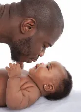 Father kisses baby girl