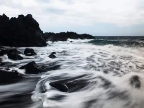 Playful waves at Playa del Bollullo