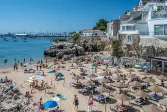 Busy Beach in Portugal with Ocean Views and Coastal Town