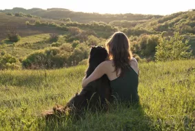 Young woman hugs her dog