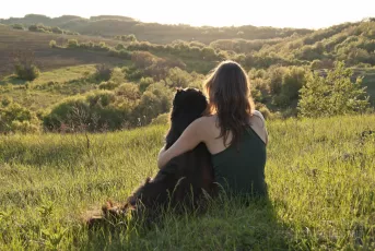 Young woman hugs her dog