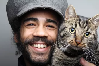 Smiling man with cat