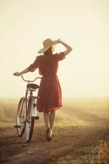 Woman in hat with a bike