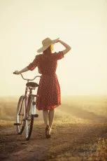 Woman in hat with a bike