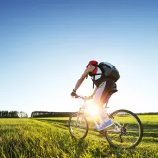 Young man cycling on a rural road