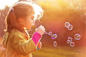 Blowing soap bubbles