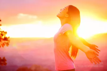 Happy woman enjoying sunset