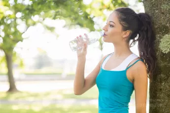 Brunette drinking water