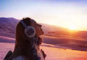 Pretty woman walking in snowy mountains