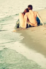 Topless couple on the beach