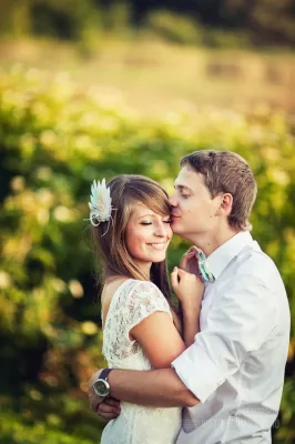 Man tenderly kissing fiancé