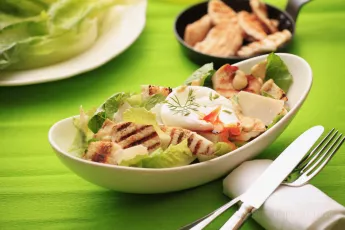 Chicken Caesar salad with poached egg