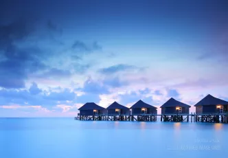 Water villa cottages at sunset