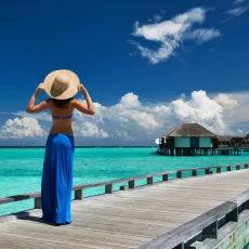 Woman on a tropical beach jetty
