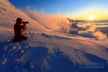Photographer on snowy mountain
