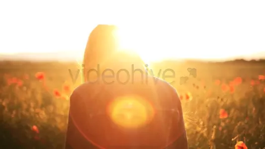Girl in the wild poppies field