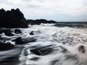 Playful waves at Playa del Bollullo