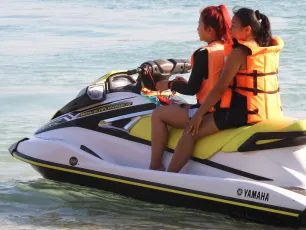 DSCN0984.JPG: Two friends in bright orange life jackets enjoying a sunny ride on a Yamaha jet ski.