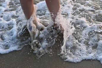 DSC_3498: Toes in the tide, playful waves washing over sandy feet at the water's edge.