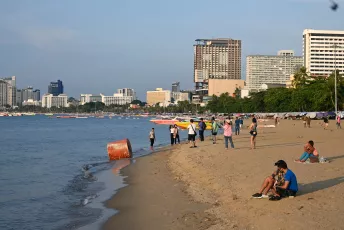 DSC_6350: Sunset strollers and beachgoers enjoy a peaceful evening along the city shoreline, with high-rises framing the distant skyline.