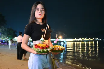 DSC_5949: a woman holding a tray of food on a beach