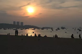 DSC_8422: a group of people standing on top of a sandy beach