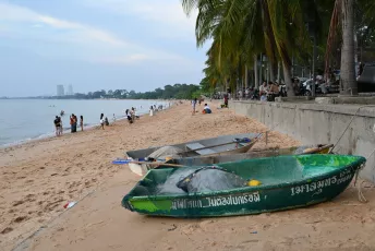 DSC_9991: a green boat sitting on top of a sandy beach