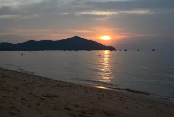 DFC_0003: the sun is setting over the water on the beach