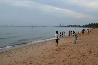 DSC_9996: a group of people standing on top of a sandy beach