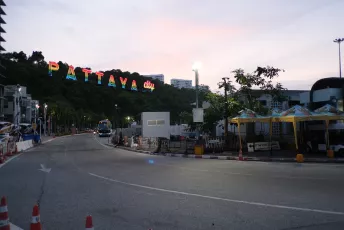 DSCF0749: Twilight on the road into Pattaya, Thailand, with the colorful "PATTAYA city" sign glowing on the hillside.