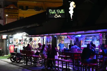 DFC_0616: Evening buzz outside the Poli Poli Bar - neon lights, laughter, and late-night chatter spilling onto the street.