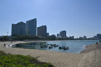 DFC_4029: Sunny morning at the city beach - small boats bobbing in the calm bay with high-rises rising in the background.
