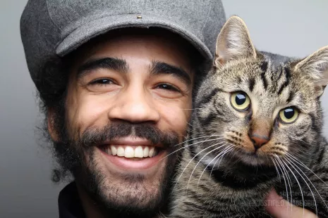 Smiling man with cat cheerful portrait of their friendship